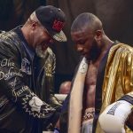 Derrick Osaze receiving the Ultimate Boxxer golden robe from Shannon Briggs. Photo Credit: London News Online