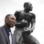 Marvis Frazier next to the statue of his father, Joe, in Philadelphia. Photo Credit: PhillyVoice.com