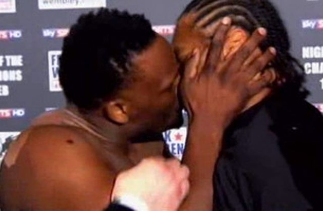 Derek Chisora landing a kiss on his opponent Carl Baker. Photo Credit: boxingnews24