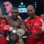 Azeez celebrates with his team after claiming the British belt Photo Credit: Lawrence Lustig/BOXXER